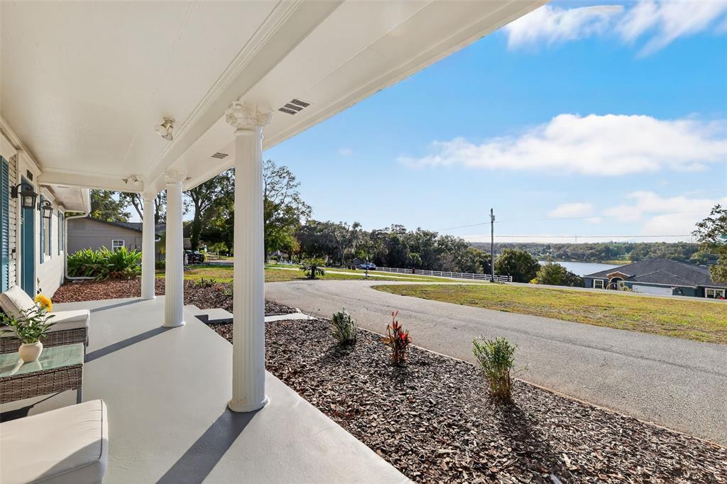 1101 Country Club Road Eustis, FL 32726 - Photo 2 of 44 a view of a swimming pool next to a lake view