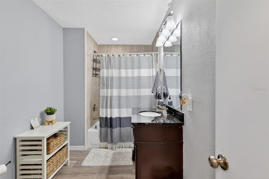 1101 Country Club Road Eustis, FL 32726 - Photo 26 of 44 a bathroom with a sink a potted plant and a shower
