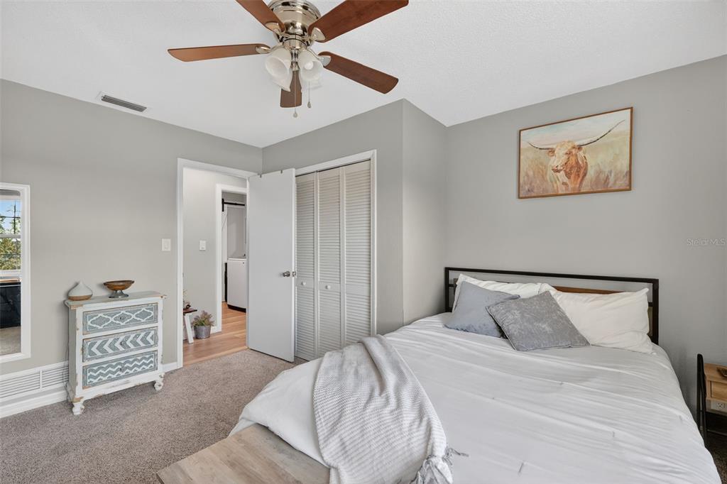 1101 Country Club Road Eustis, FL 32726 - Photo 28 of 44 a bedroom with a bed and a cabinets