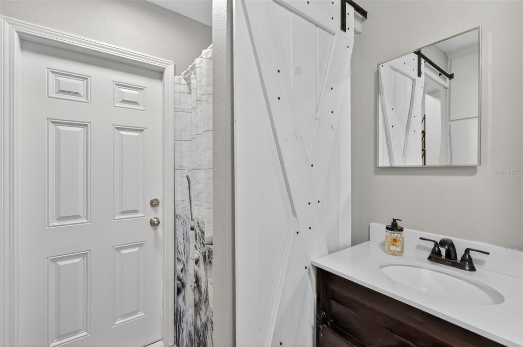 1101 Country Club Road Eustis, FL 32726 - Photo 30 of 44 a bathroom with a sink vanity and a mirror