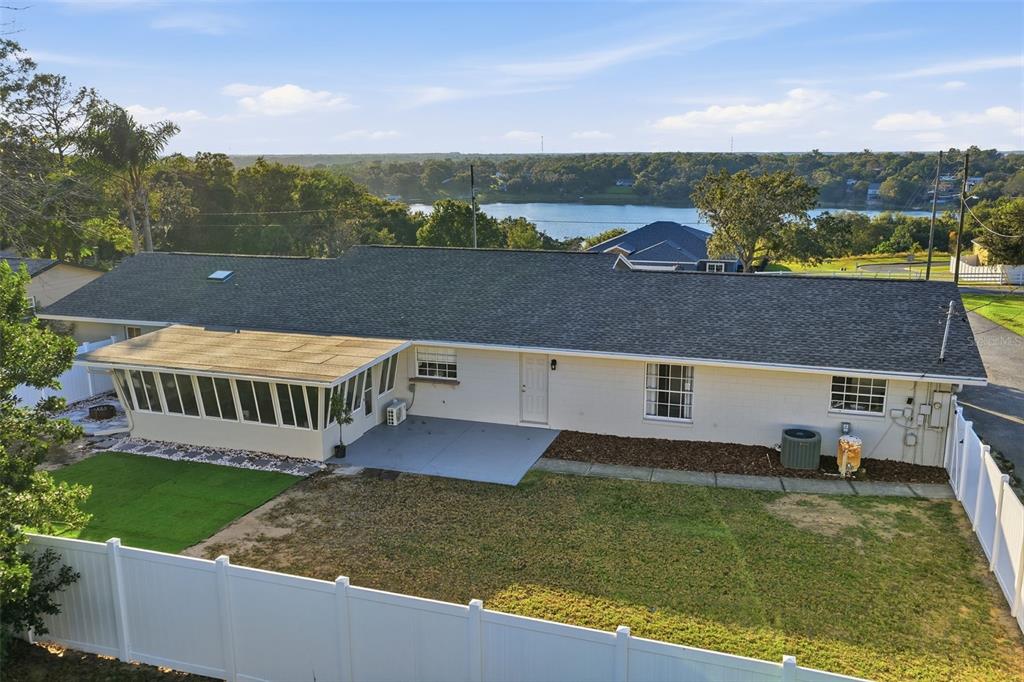 1101 Country Club Road Eustis, FL 32726 - Photo 35 of 44 an aerial view of a house with a garden and lake view