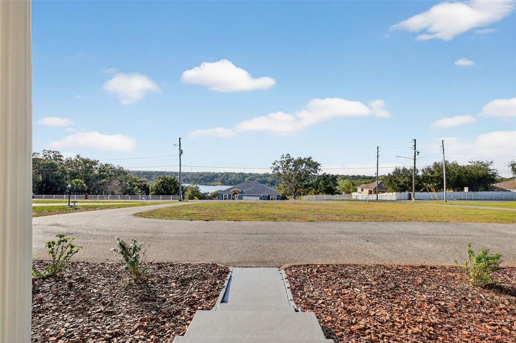 1101 Country Club Road Eustis, FL 32726 - Photo 39 of 44 a view of a swimming pool and a yard