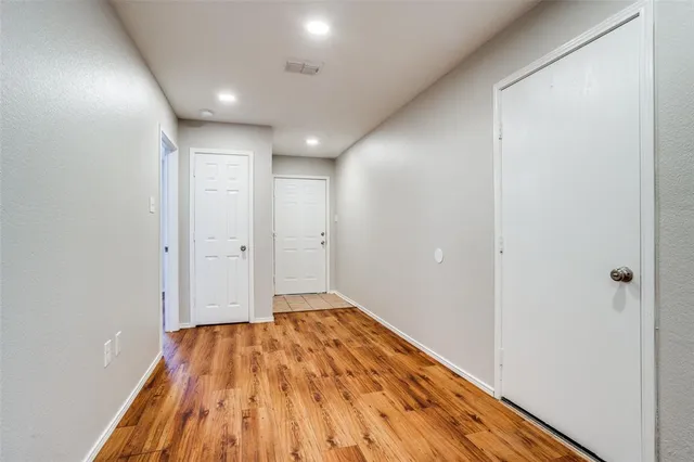 a view of hallway with wooden floor
