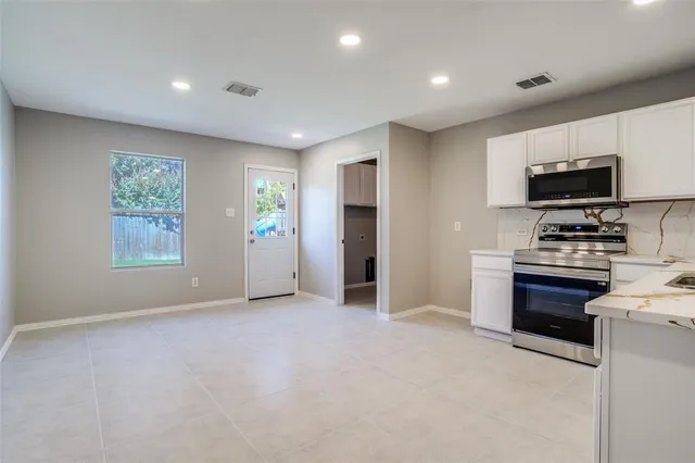 a view of kitchen appliances and cabinets in the room