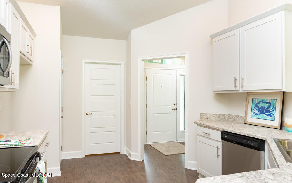 318 Trilby Road Southwest Palm Bay, FL 32908 - Photo 3 of 17 a spacious bathroom with a granite countertop sink and a mirror