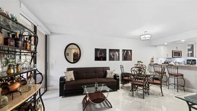 a living room with furniture a rug and a window