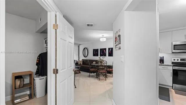 a view of living room kitchen with furniture and flat screen tv