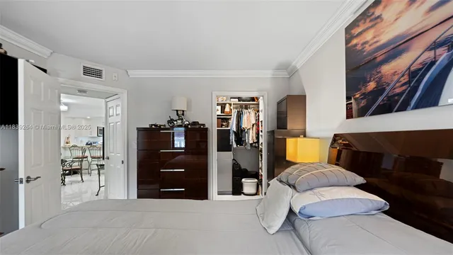 a living room with furniture and a walk in closet