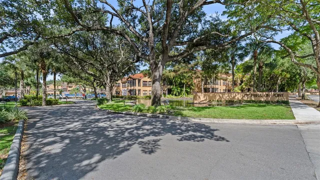 a view of a house with a yard and plants