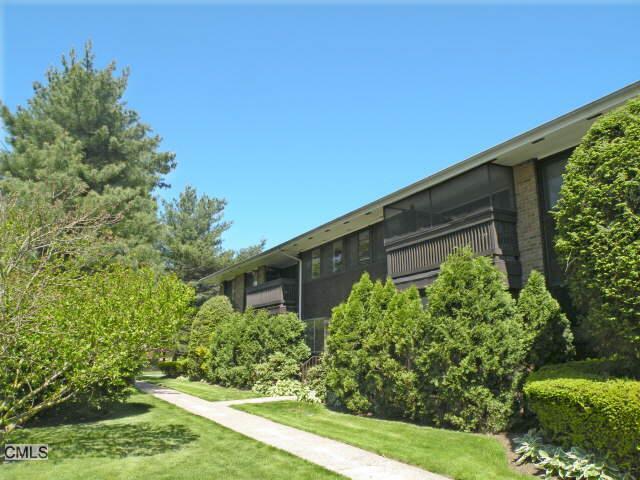 a backyard of a house with lots of green space and garden