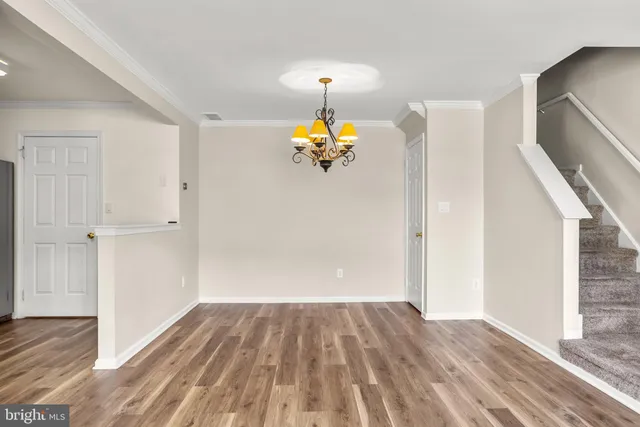 a very nice looking room with wooden floor and windows