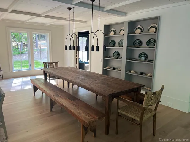 a view of a dining room with furniture and window