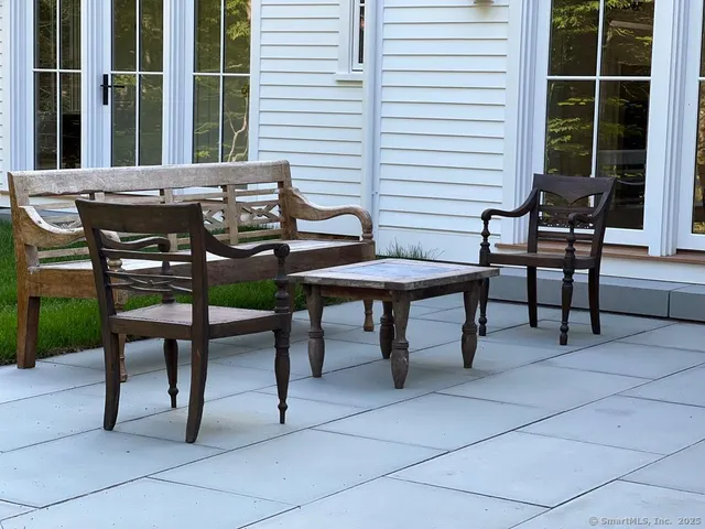 a view of a house with backyard and sitting area