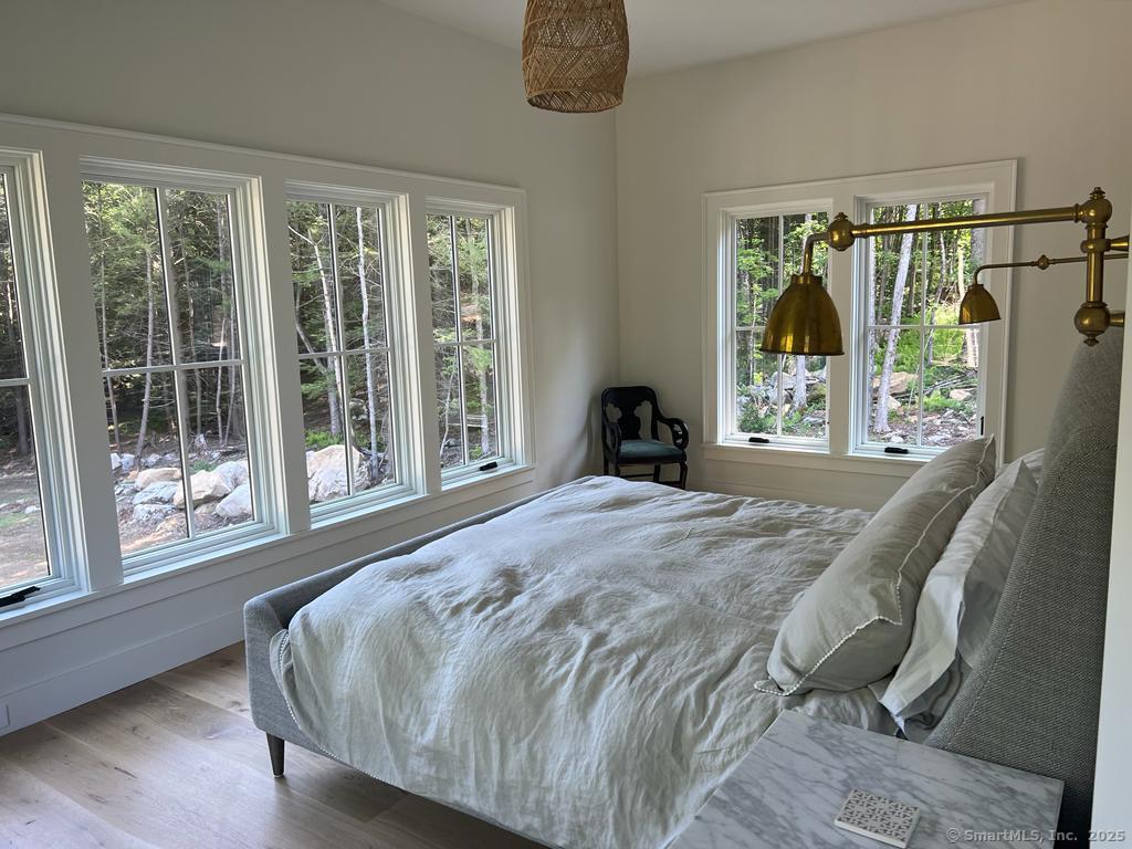 Undisclosed Address Litchfield, CT 06759 - Photo 16 of 22 a bedroom with a bed and a large window