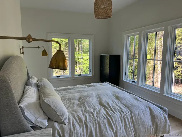 a bed sitting in a bedroom next to a window