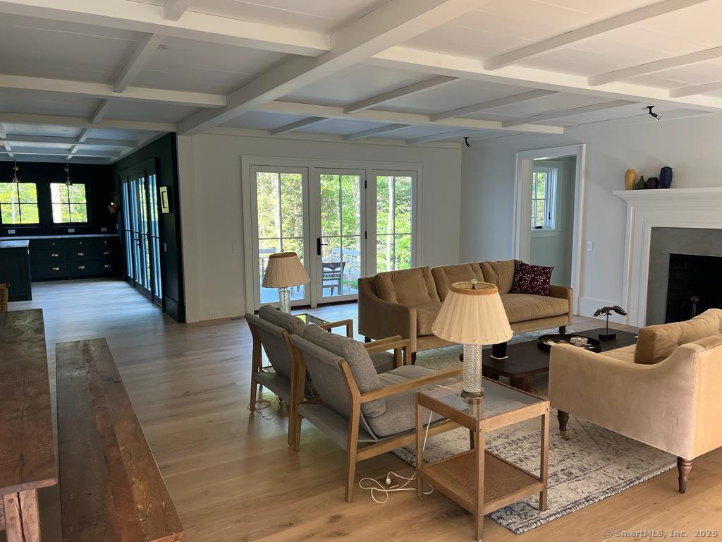 Undisclosed Address Litchfield, CT 06759 - Photo 2 of 22 a living room with furniture a fireplace and a table