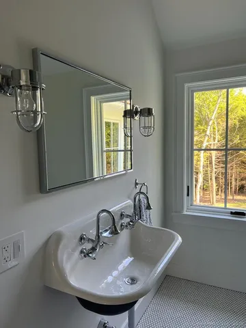 a bathroom with a sink and a window