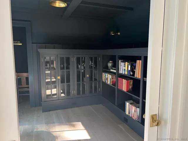a living room with lots of furniture and a book shelf