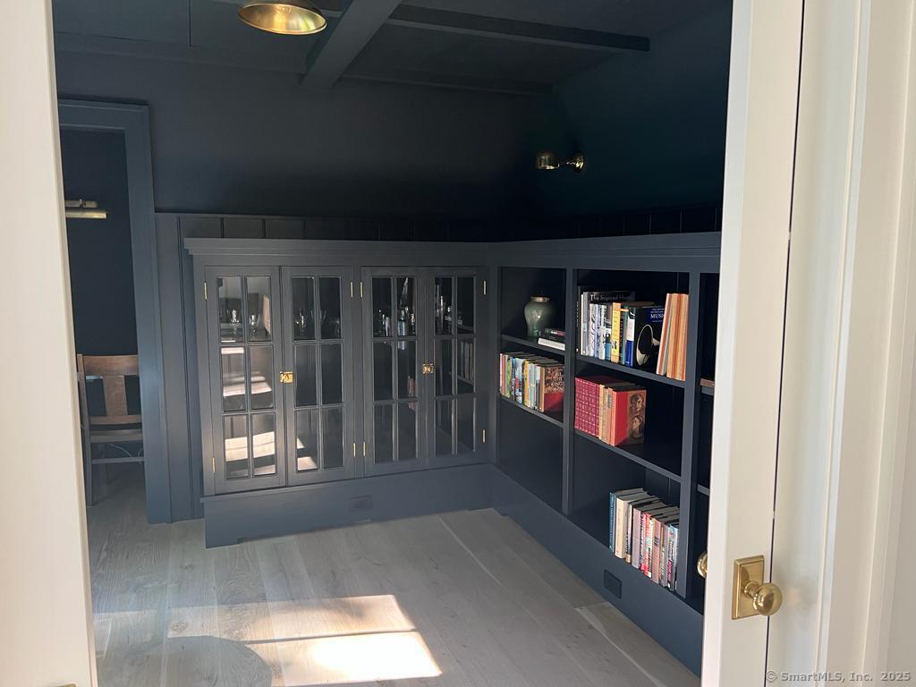 Undisclosed Address Litchfield, CT 06759 - Photo 5 of 22 a living room with lots of furniture and a book shelf