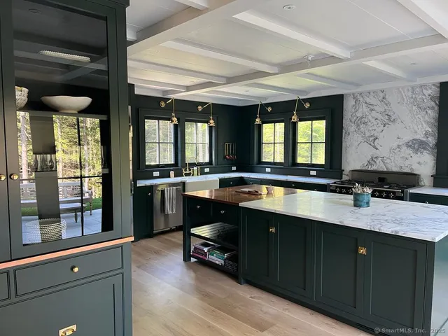 a kitchen with a sink appliances and cabinets