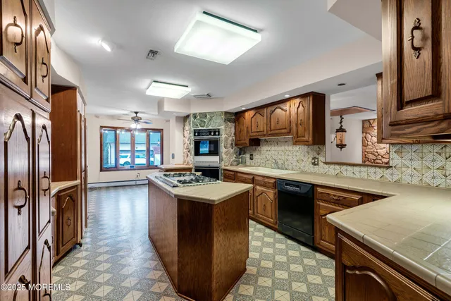 a view of a refrigerator in kitchen and an windows