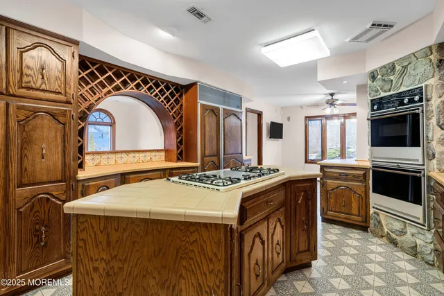 a view of a hallway with wooden floor and entryway