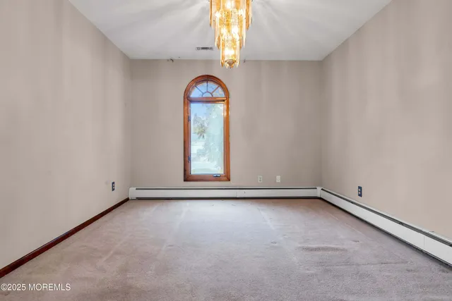 a view of a livingroom with an empty space and a fireplace