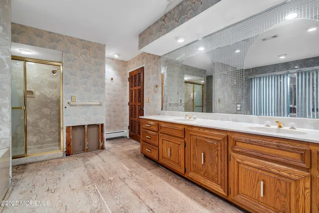 a kitchen with a sink and a stove with wooden floor