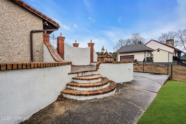a view of a house with a backyard and basketball court