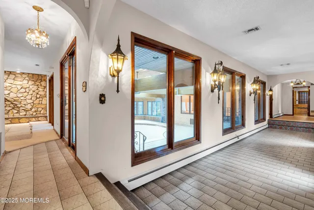 a view of a livingroom with furniture and chandelier fan
