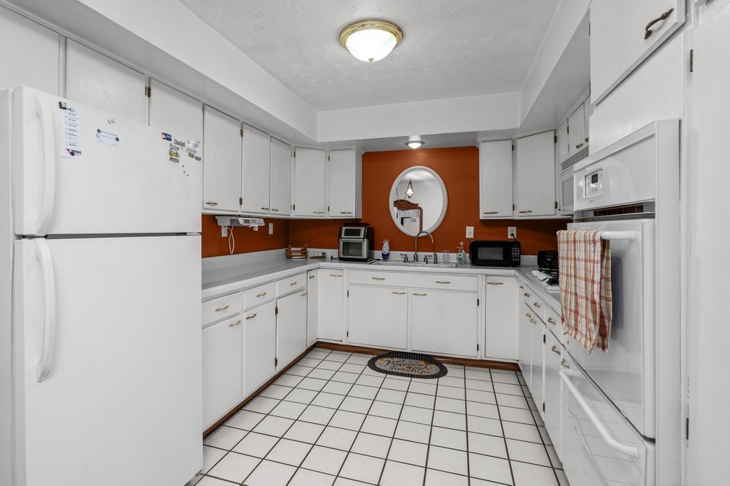 11213 22nd Street Milan, IL 61264 - Photo 25 of 36 a kitchen with a refrigerator and a stove top oven