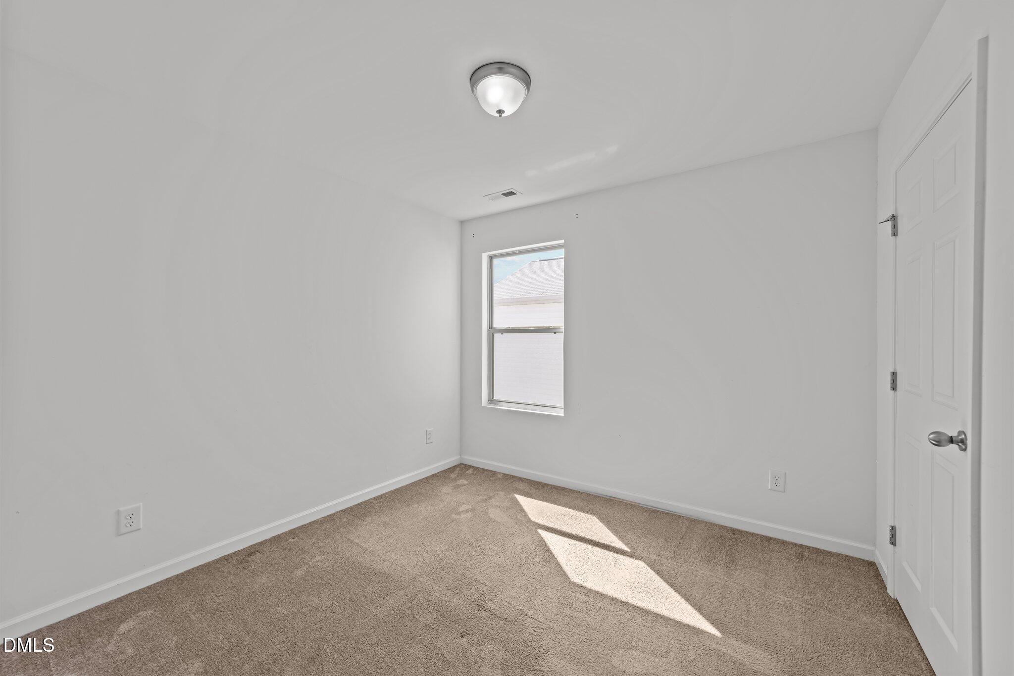 1445 Lombar Street Raleigh, NC 27610 - Photo 12 of 20 a view of an empty room with a window