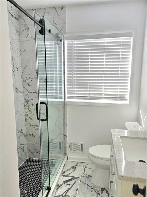 522 Wimbledon Road Northeast Atlanta, GA 30324 - Photo 11 of 15 a bathroom with a shower a toilet and a window