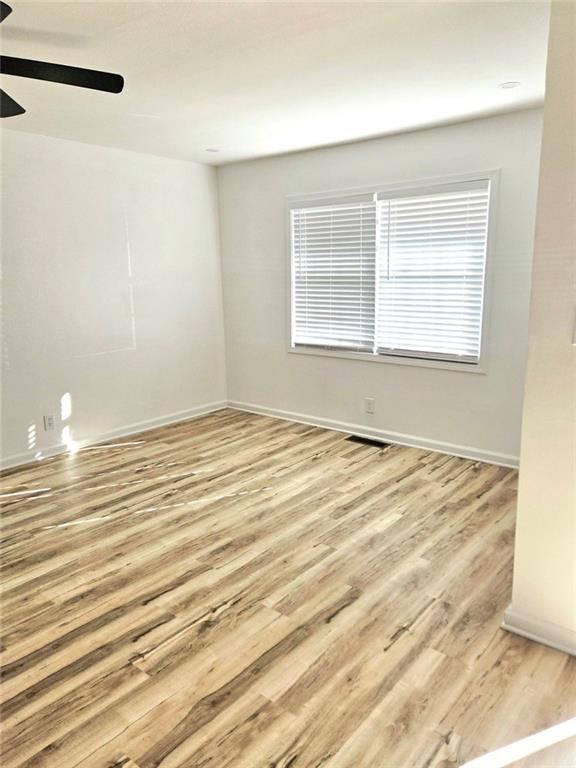 522 Wimbledon Road Northeast Atlanta, GA 30324 - Photo 3 of 15 a view of a room with wooden floor and white walls