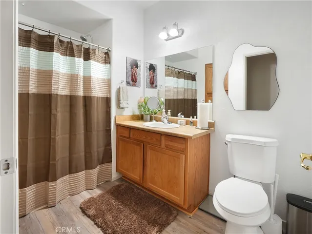 a bathroom with a toilet a sink and a mirror
