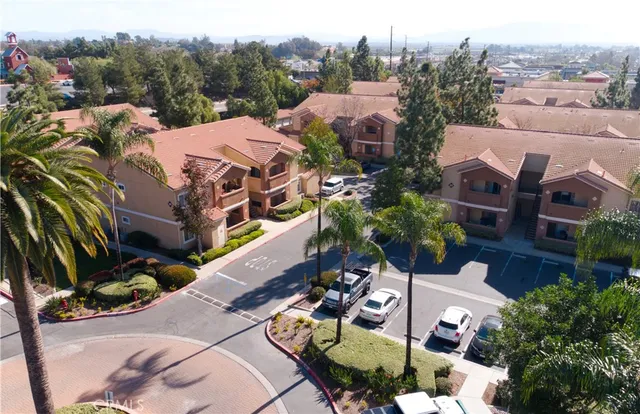an aerial view of multiple houses with yard