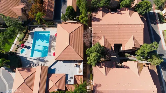 an aerial view of a house with a yard and seating area