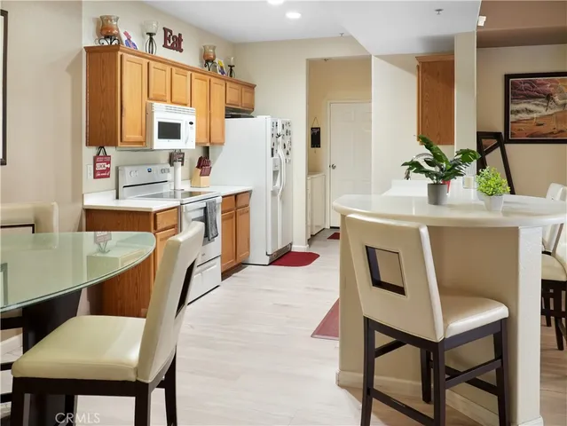 a kitchen with stainless steel appliances a stove a sink refrigerator and a refrigerator