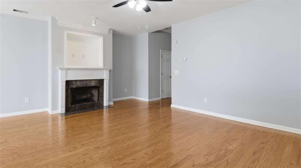 3522 Spring View Court Alpharetta, GA 30004 - Photo 19 of 25 wooden floor in an empty room with a fireplace