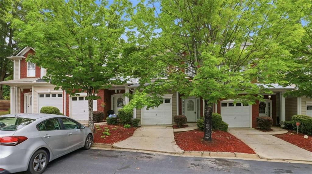 3522 Spring View Court Alpharetta, GA 30004 - Photo 2 of 25 a front view of a house with a garden and tree