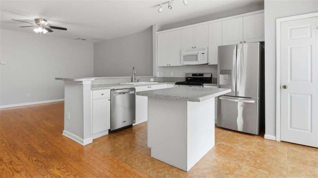 3522 Spring View Court Alpharetta, GA 30004 - Photo 4 of 25 a kitchen with a stove a refrigerator and a microwave
