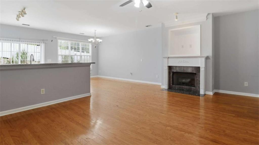 3522 Spring View Court Alpharetta, GA 30004 - Photo 7 of 25 an empty room with wooden floor fireplace and windows