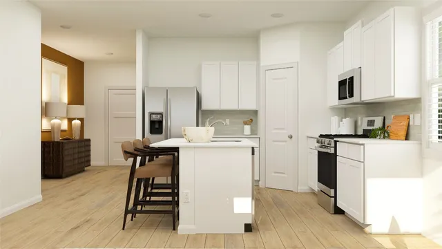 a kitchen with a refrigerator a sink and cabinets
