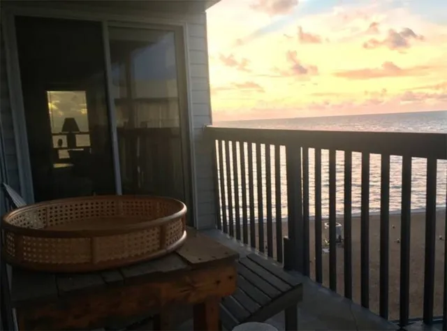 a view of balcony with wooden floor