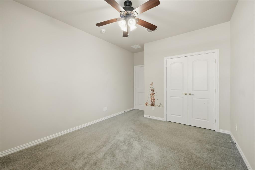 12809 Spring Hill Drive Frisco, TX 75035 - Photo 31 of 37 an empty room with chandelier fan