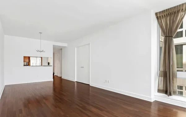 a view of a room with wooden floor and brick wall