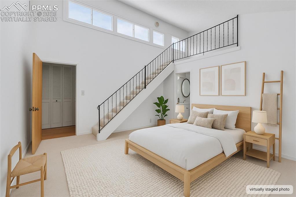 24975 Sanborn Road Calhan, CO 80808 - Photo 21 of 50 a bed room with a bed and a chandelier