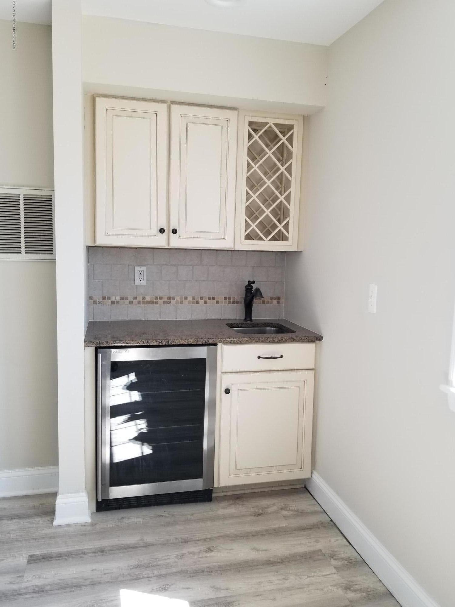 1521 Treeneedle Road Point Pleasant, NJ 08742 - Photo 11 of 33 a kitchen with a stove and white cabinets