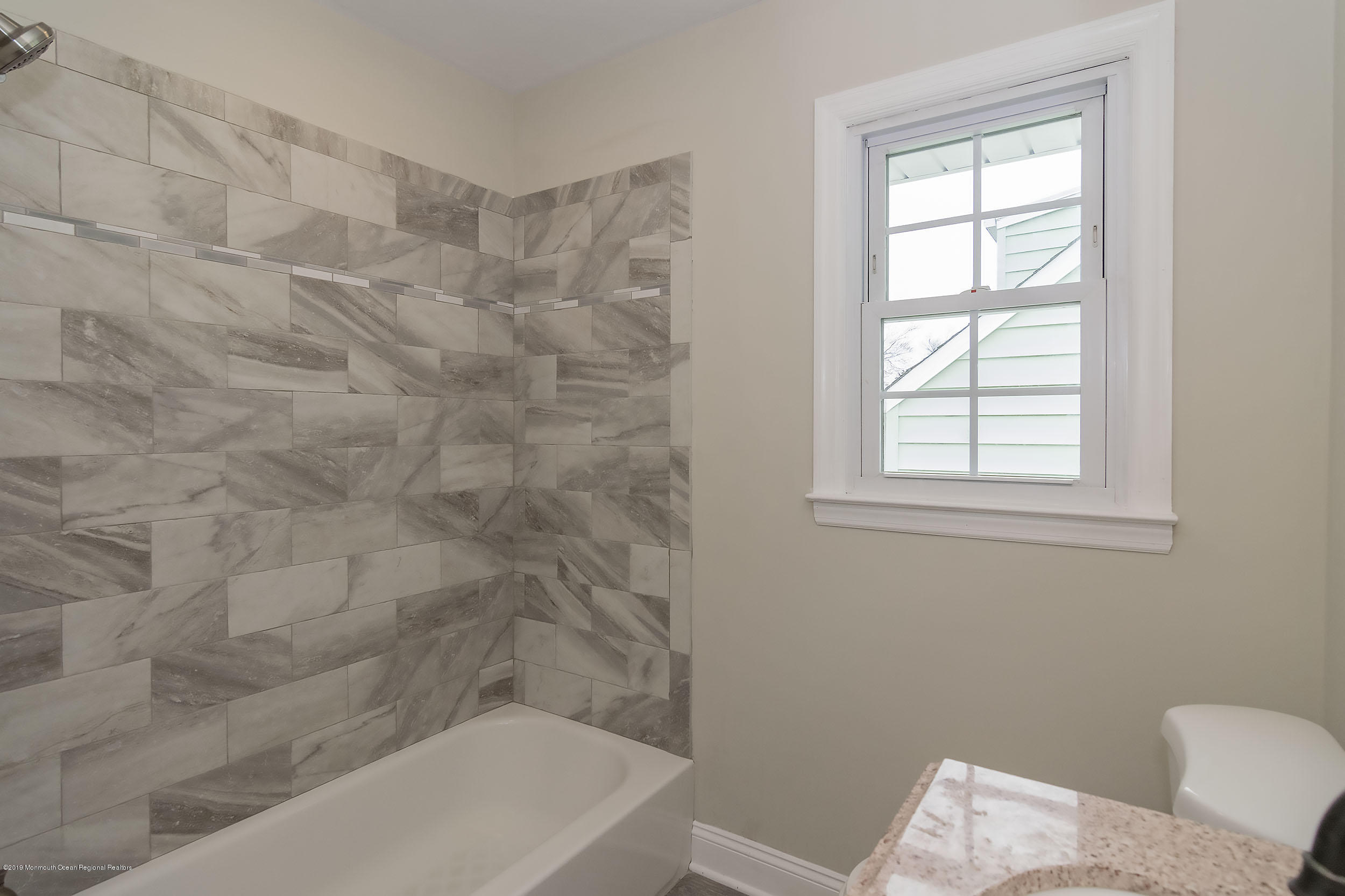 1521 Treeneedle Road Point Pleasant, NJ 08742 - Photo 25 of 33 a bathroom with a bathtub and window