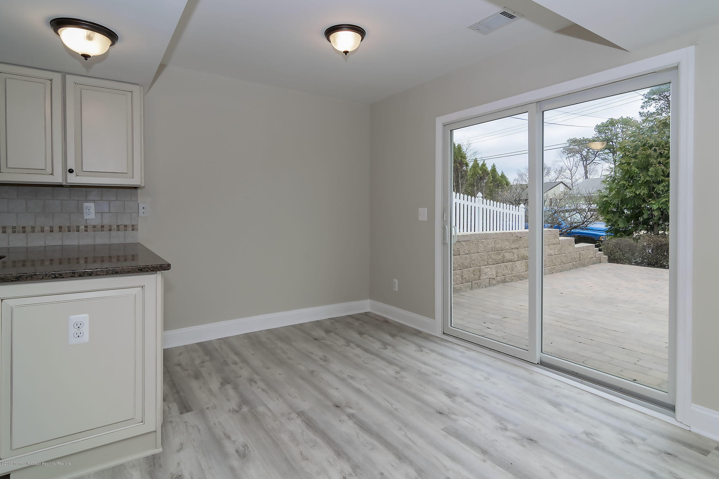 1521 Treeneedle Road Point Pleasant, NJ 08742 - Photo 8 of 33 an empty room with wooden floor and windows
